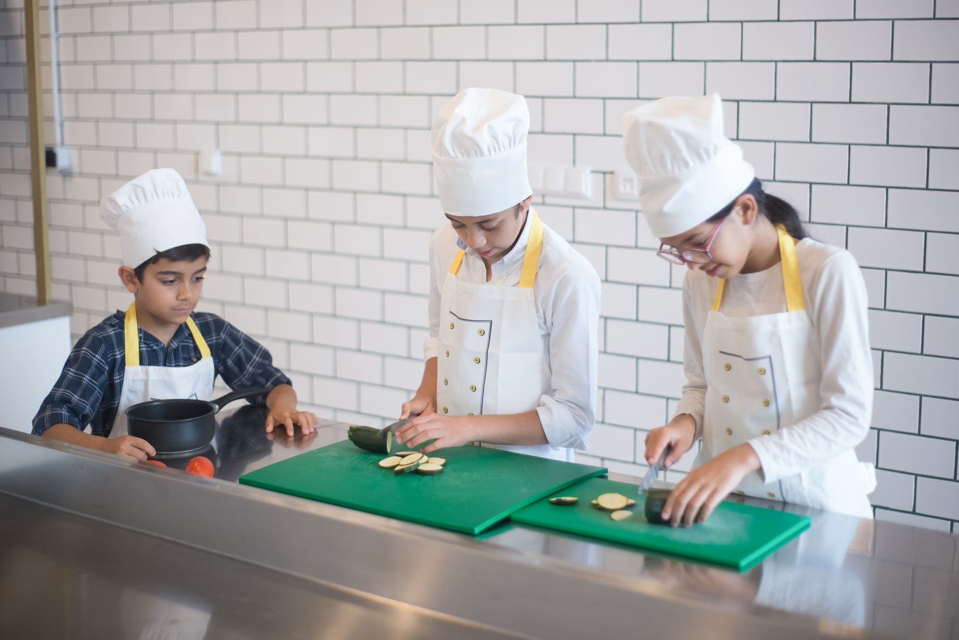 chef teaching couple cooking