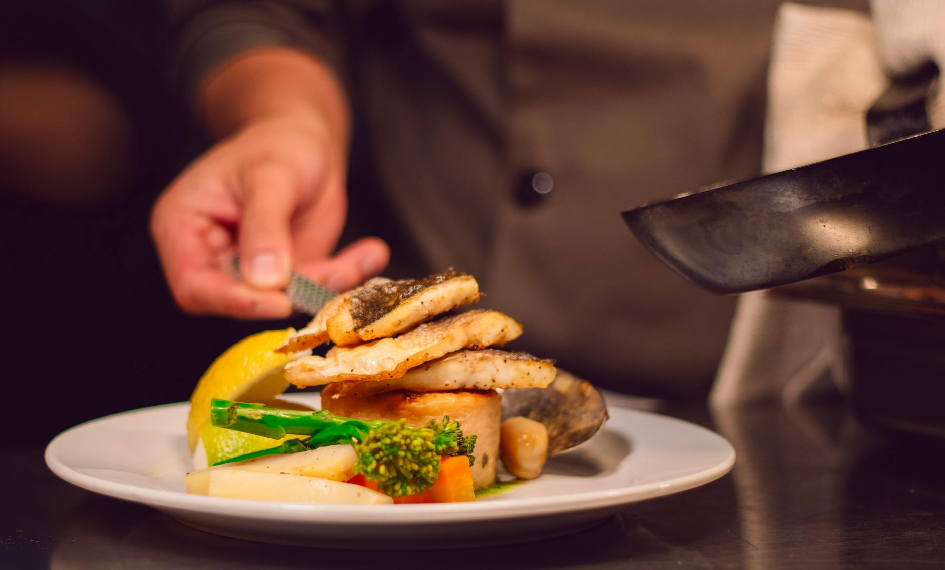chef preparing fish dish